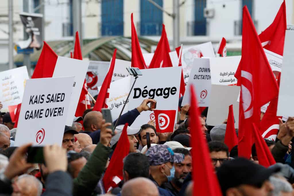 Demonstrators hold placards during a protest against Tunisian President Kais Saied, on the anniversary of the 2011 uprising, in Tunis, Tunisia January 14, 2023. REUTERS/Zoubeir Souissi